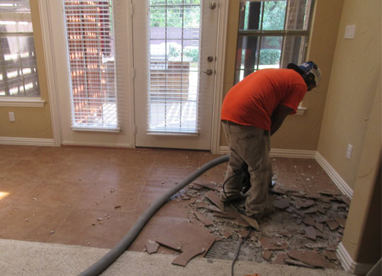 Professional worker removing tile in Dallas Fort Worth